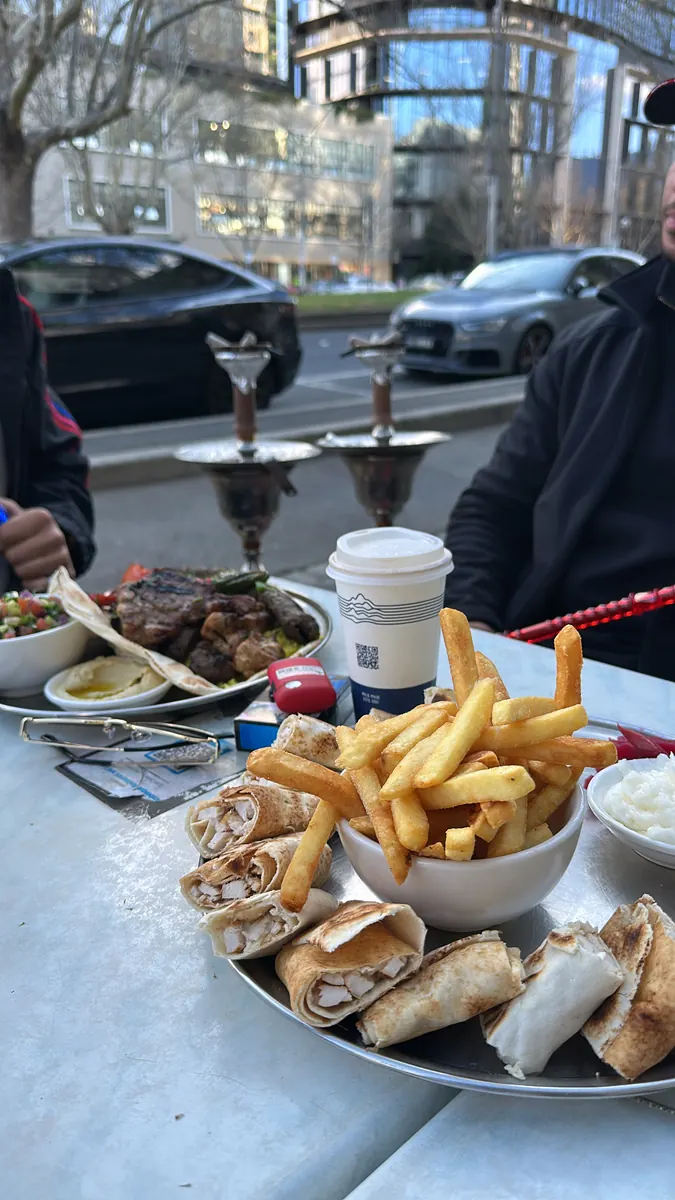 Shawarma, chips and mixed grill at the outdoor tables