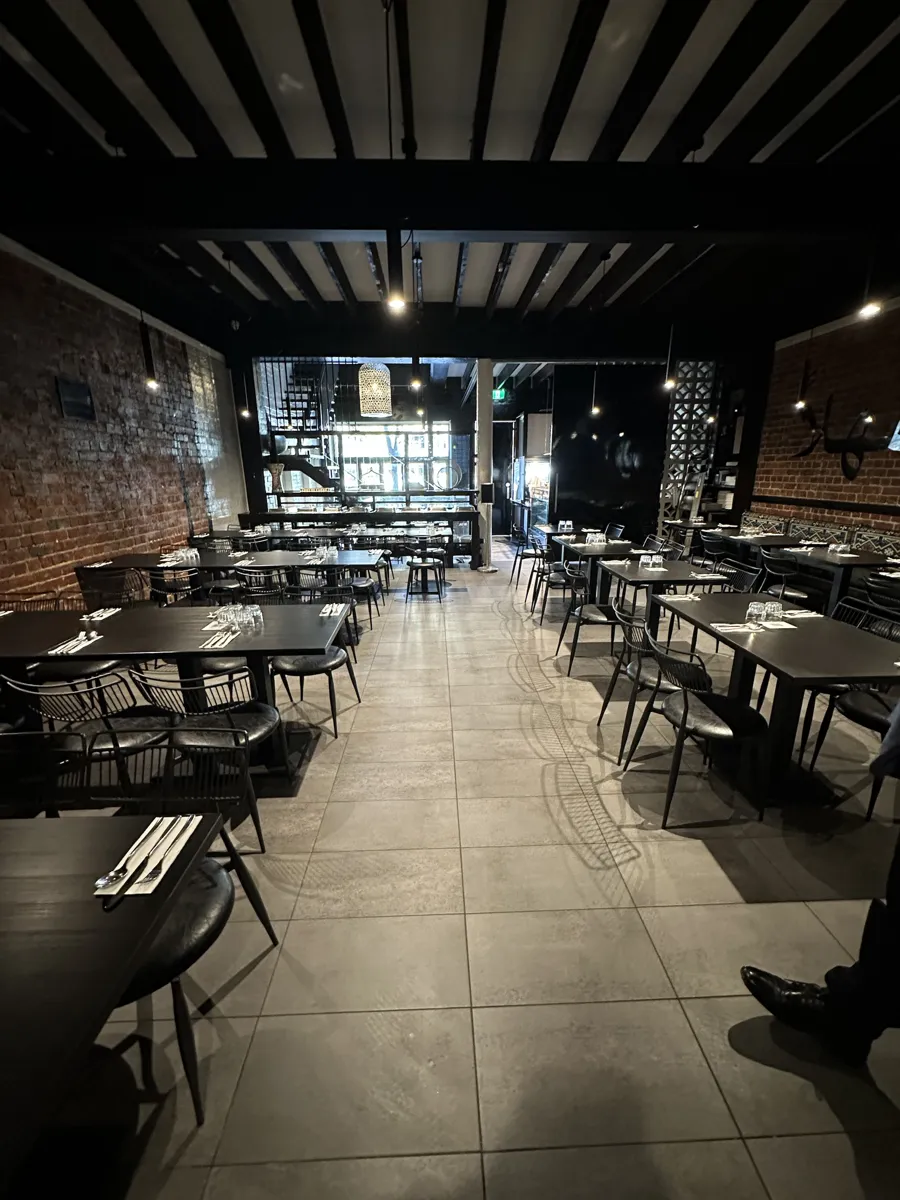 The downstairs dining room with exposed brick, set for service