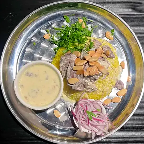 Mansaf, lamb in jameed sauce over rice with almonds
