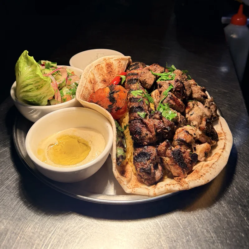 Mixed skewers of lamb, chicken and kofta on pita